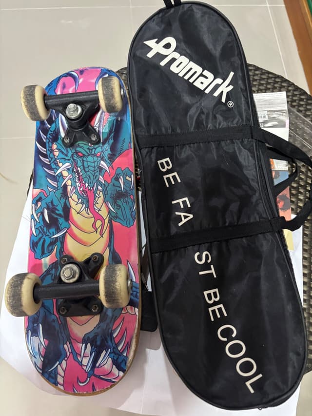 Used skateboard with dragon graphic