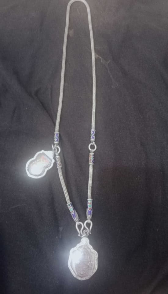 2 Buddha amulets with a silver necklace