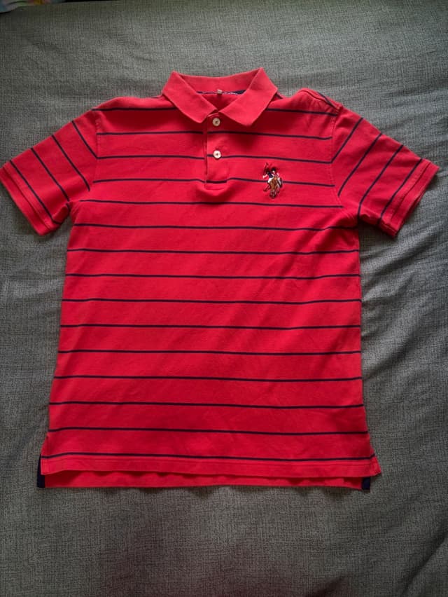 U.S. POLO ASSN. Red polo shirt with horizontal stripes and embroidered logo on the left chest